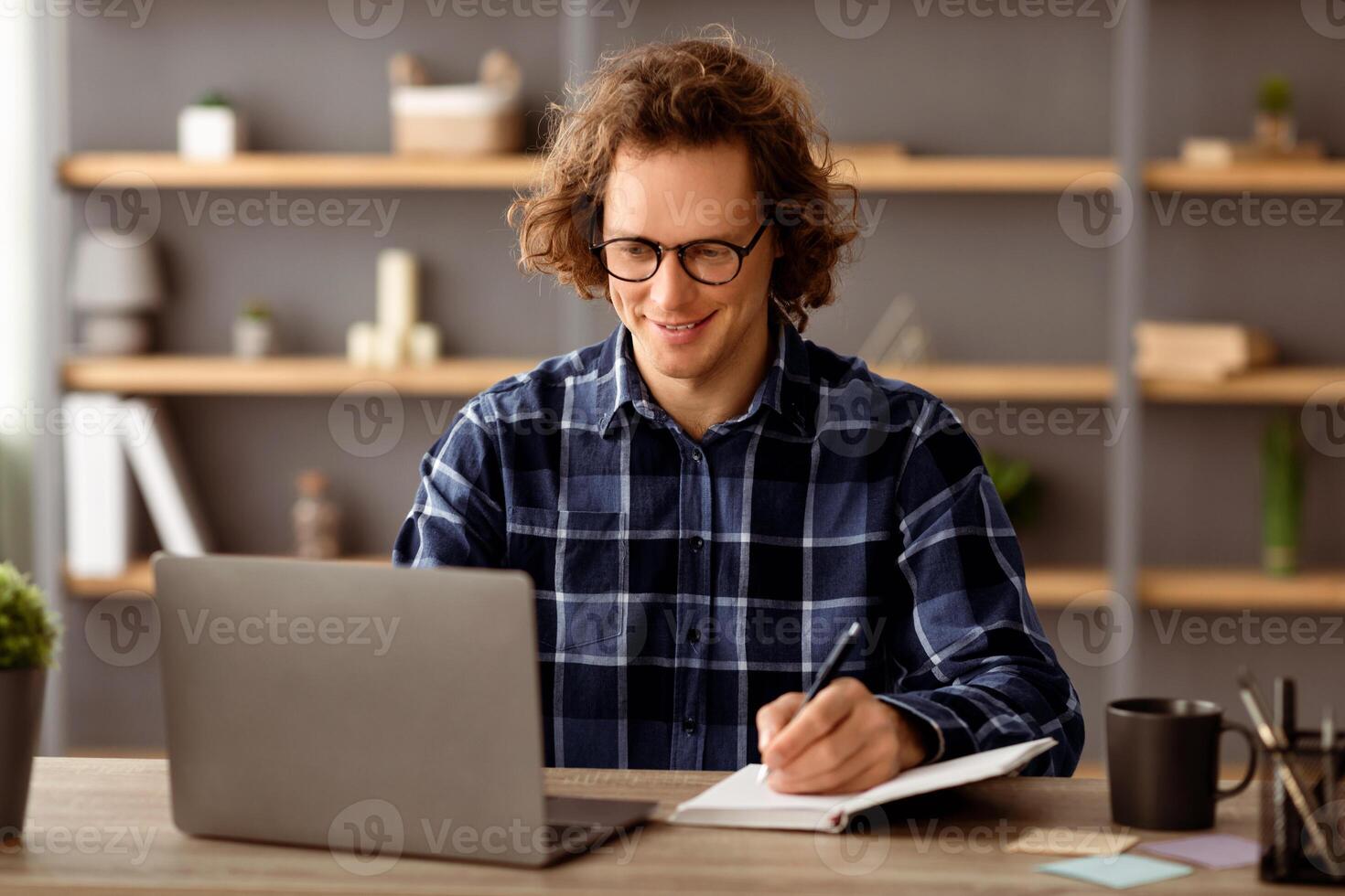 Successful Businessman At Laptop Computer Writing Taking Notes Sitting At Workplace In Modern Office. Cheerful Employee Making Business Report At Work. Entrepreneurship Career Concept photo