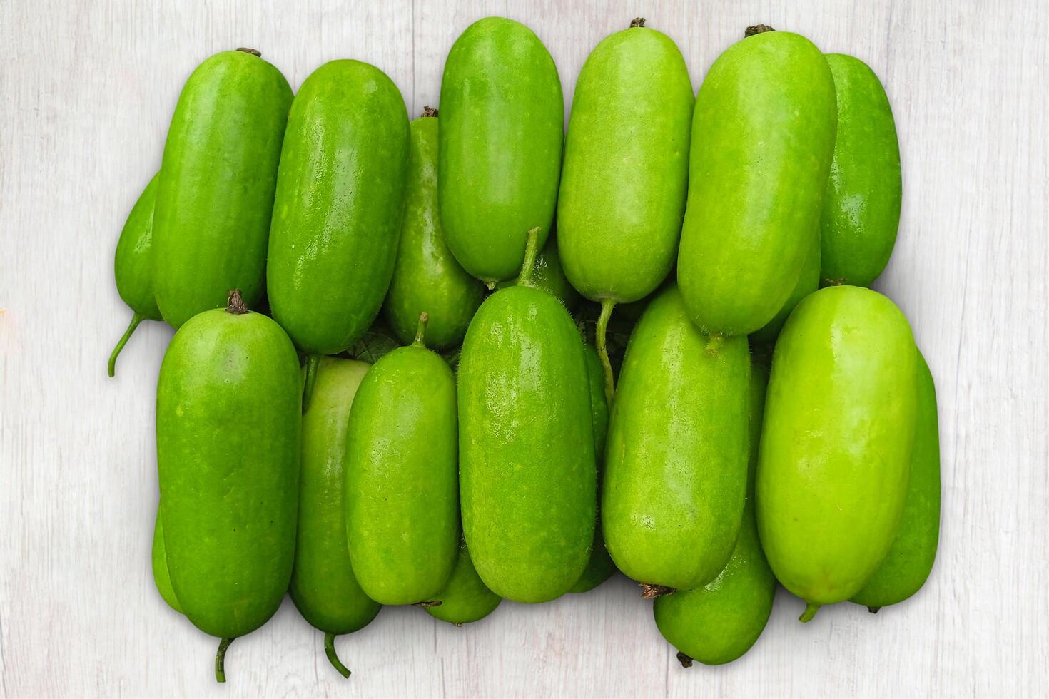 Water pumpkin on wooden background. called Jali Kumra in the Indian language. Fresh Green vegetable photo