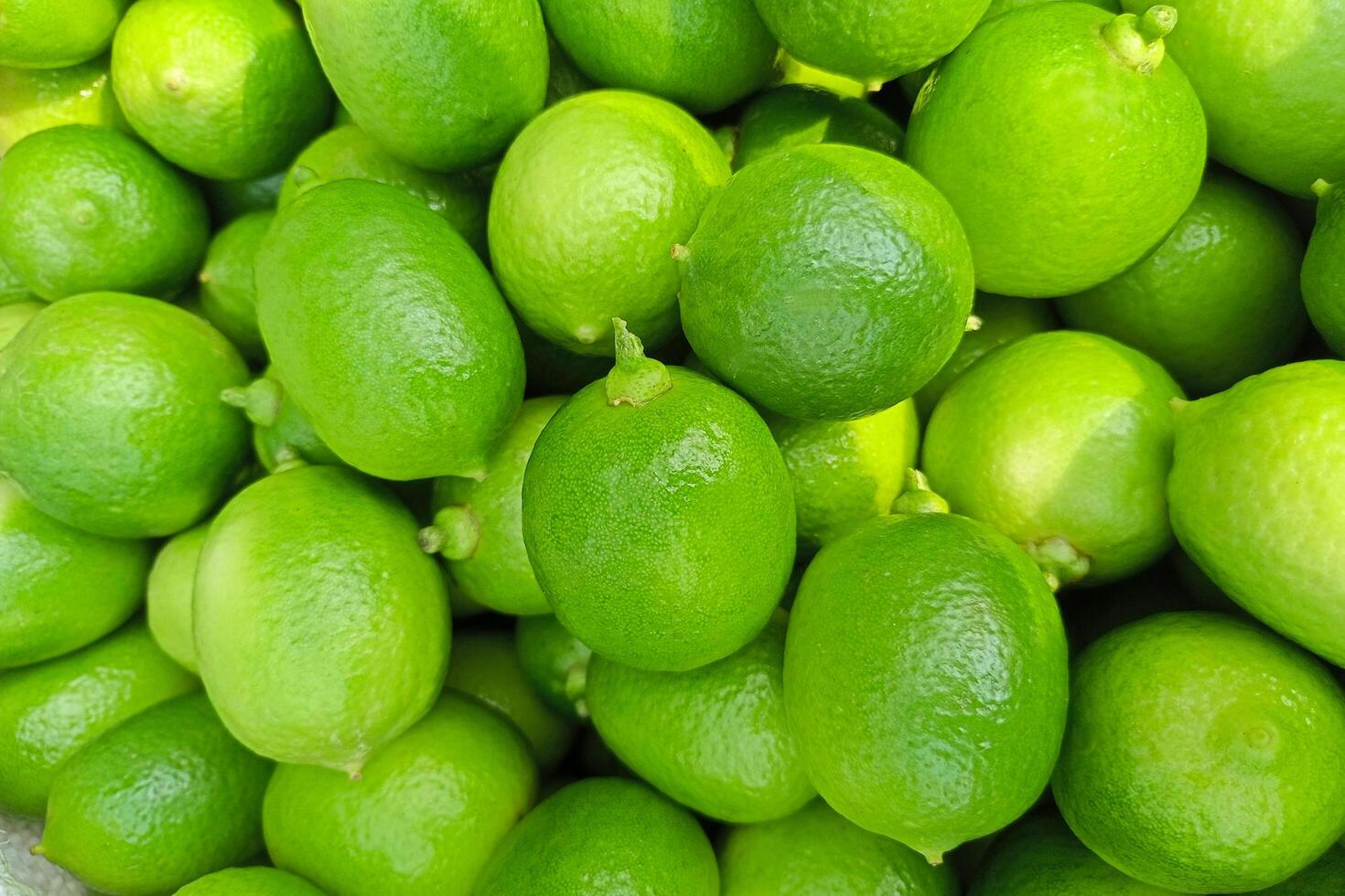 Green Fresh Lemons, Fresh Green Juicy Refreshing Vitamin C Filled Organic Health Limes. use it to make a background photo