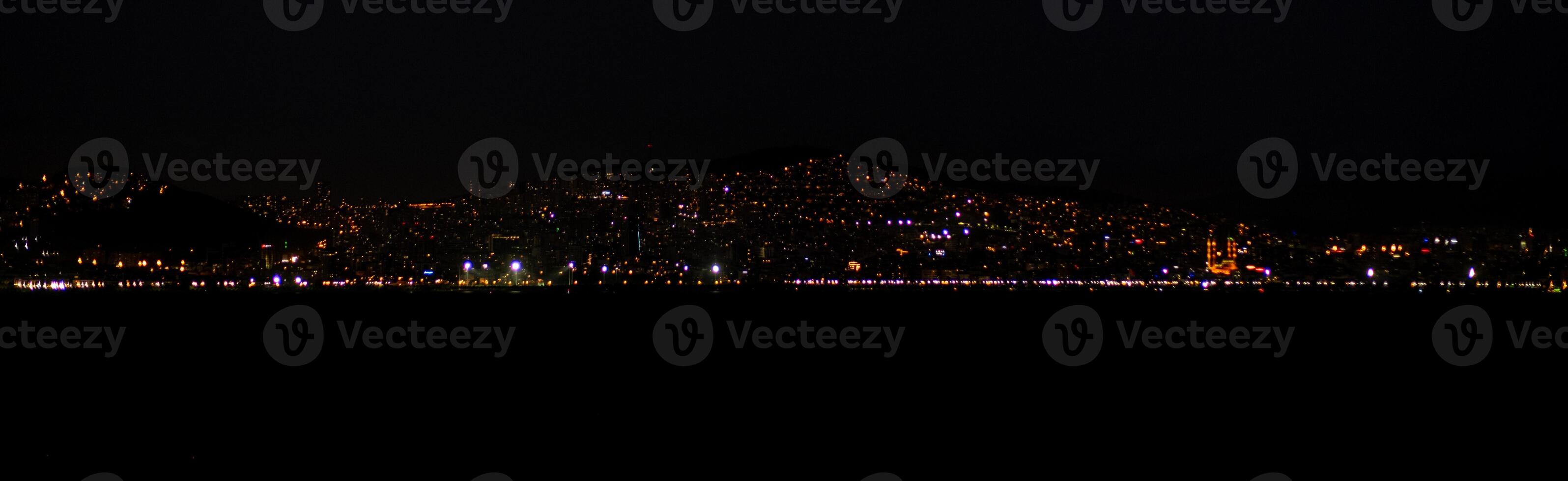 The skyline of Istanbul sparkles at night with countless lights reflecting photo