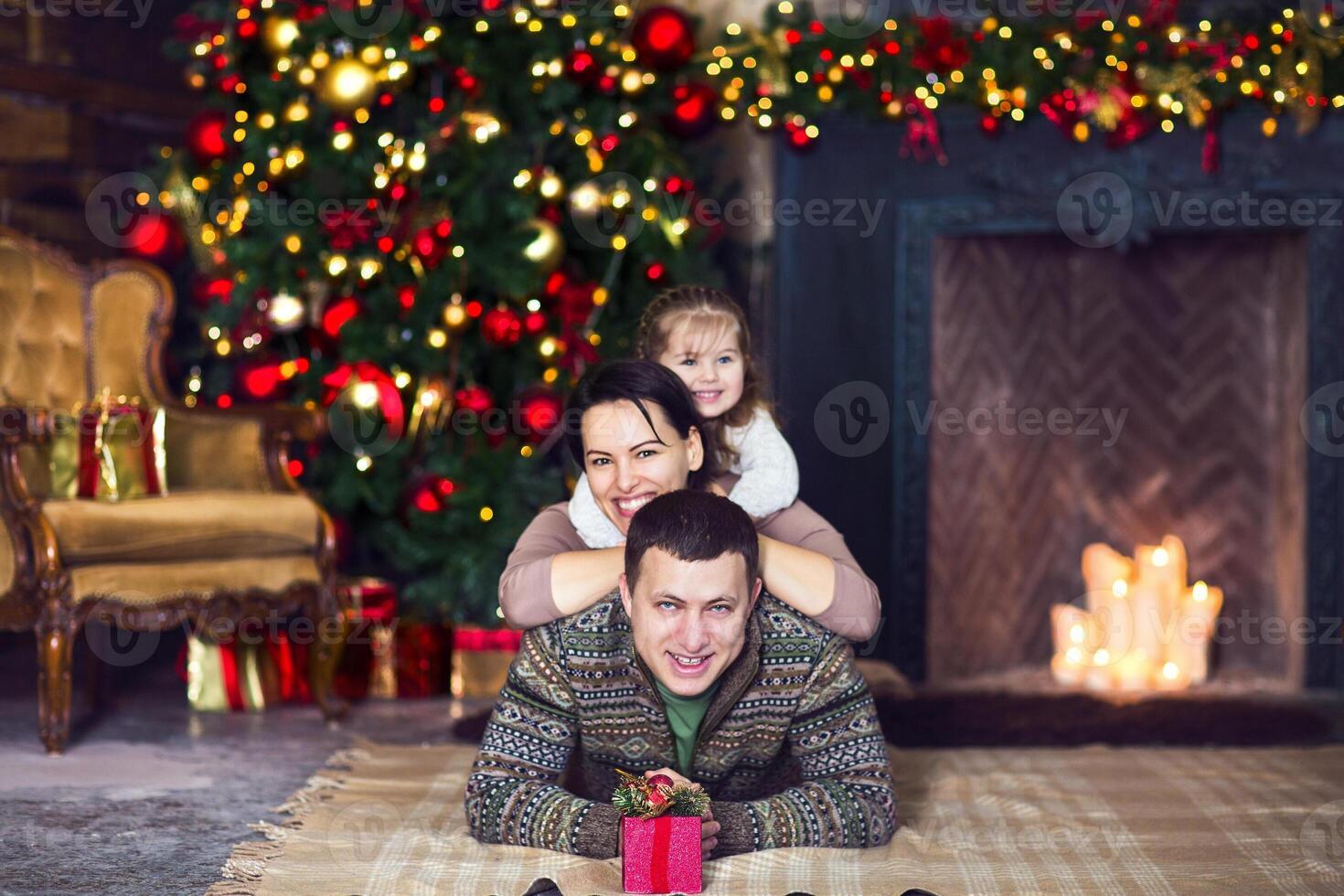 Christmas family portrait with decorated Christmas tree photo