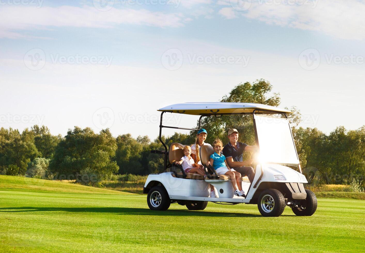 Beautiful family portrait in a cart, at the golf course photo