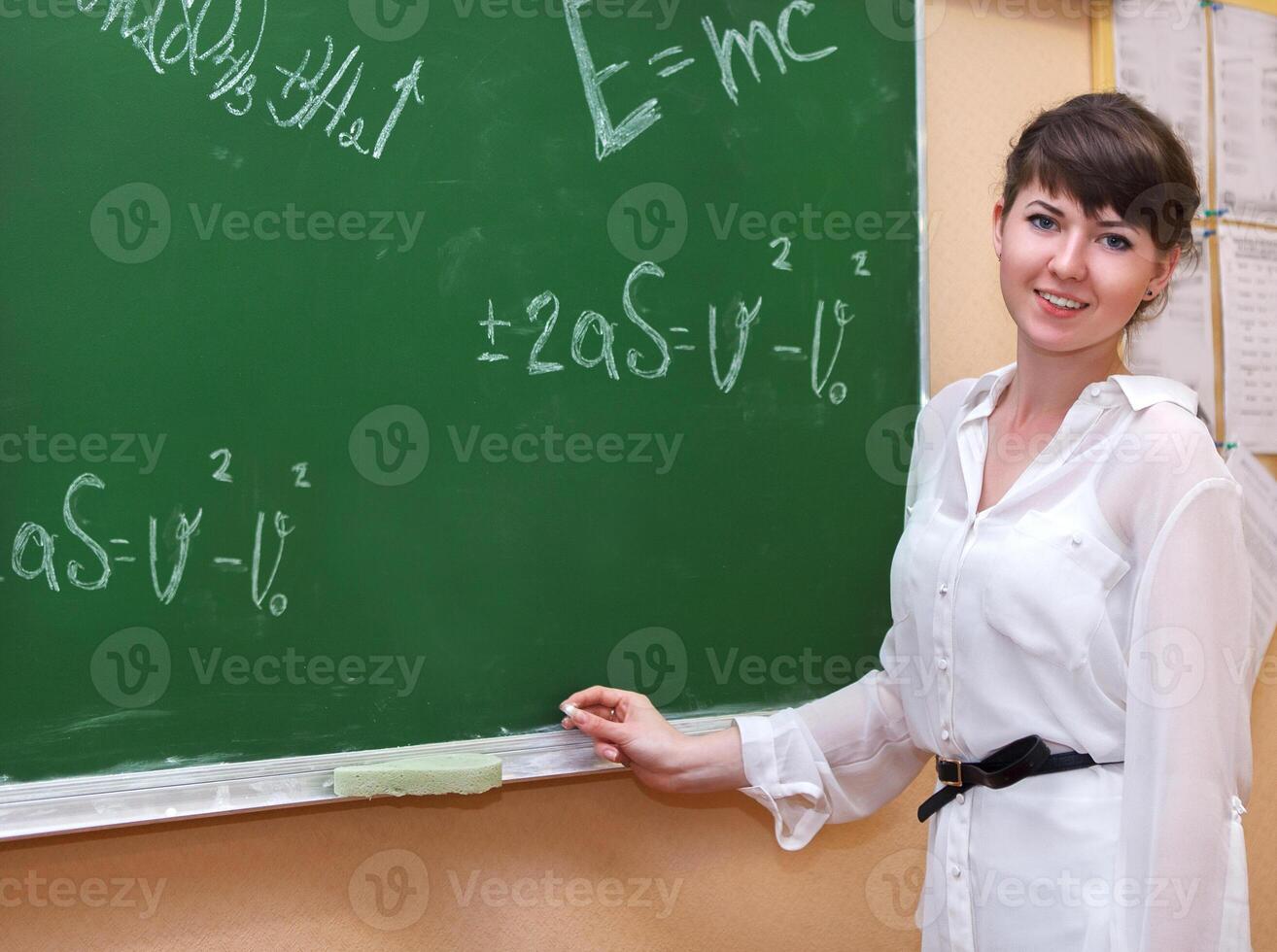 A Student girl standing near blackboard photo