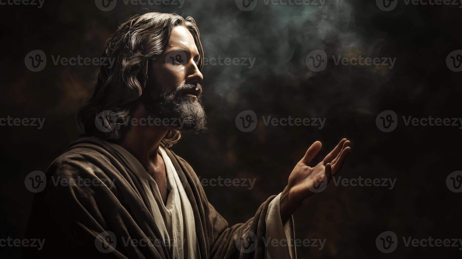 Resurrected jesus christ reaching out in prayer against a dark and dramatic backdrop photo