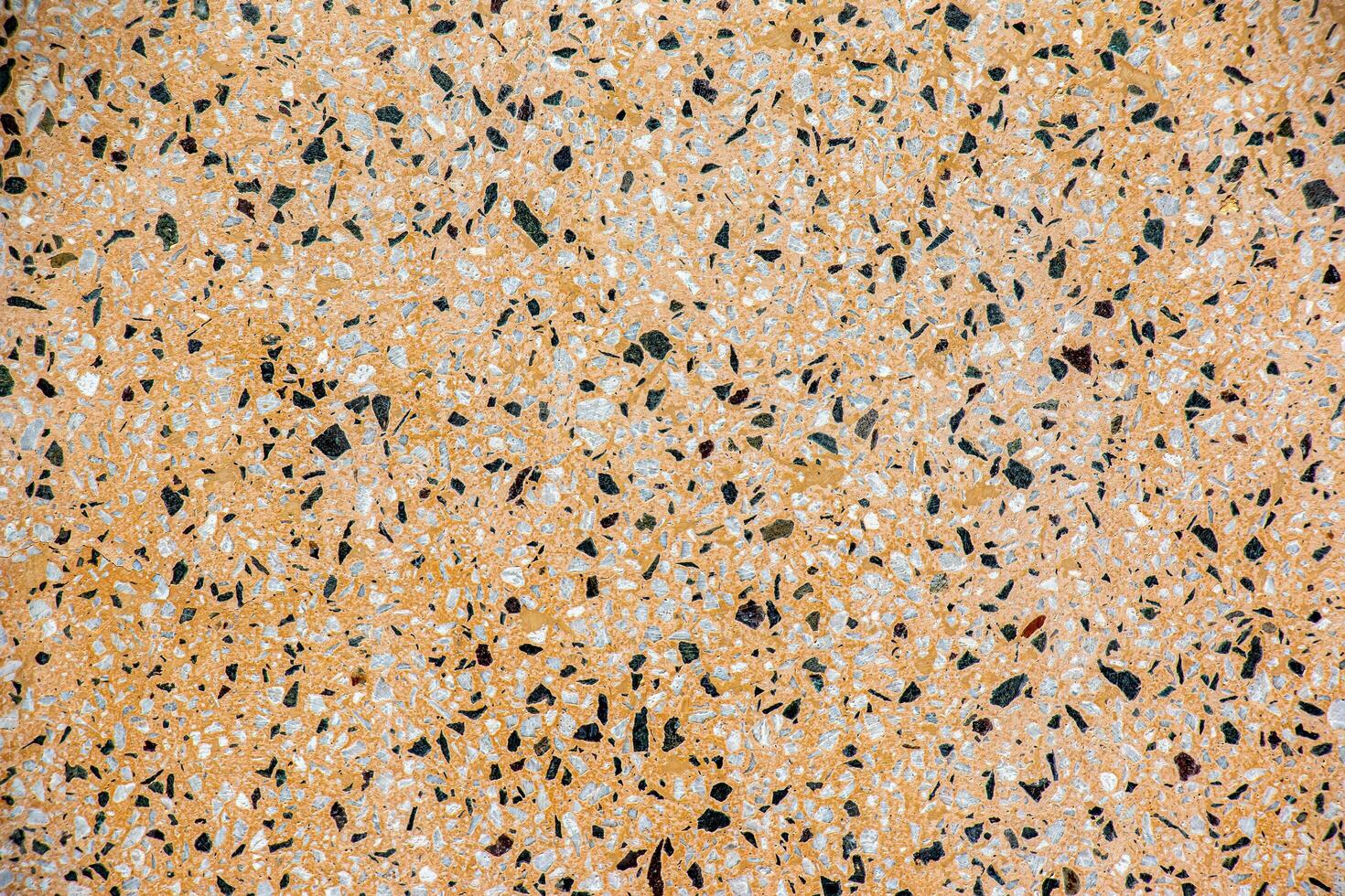 The texture of the stone wall. Abstract background with small multicolored stone particles. photo