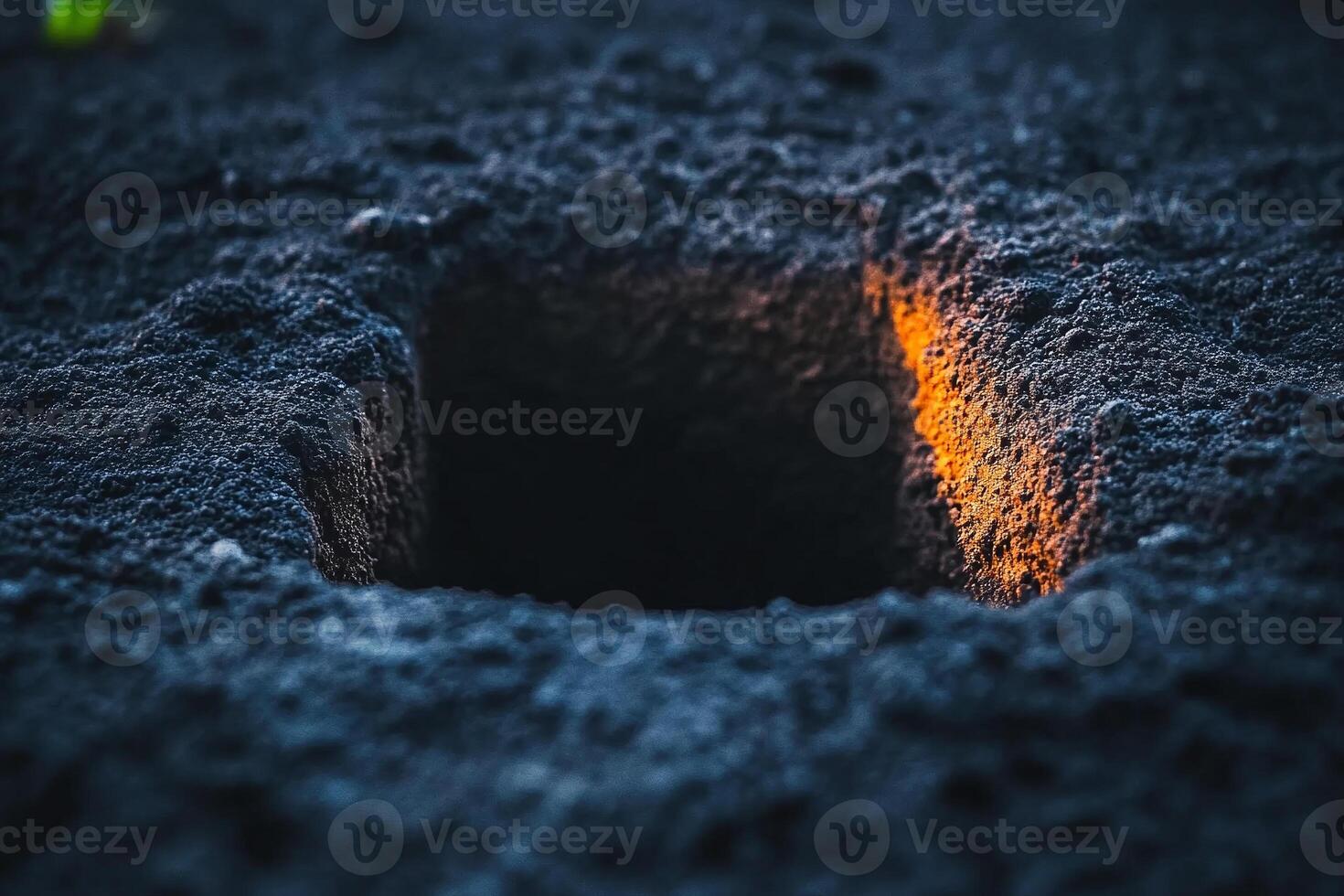A hole in the ground with a small hole in it photo