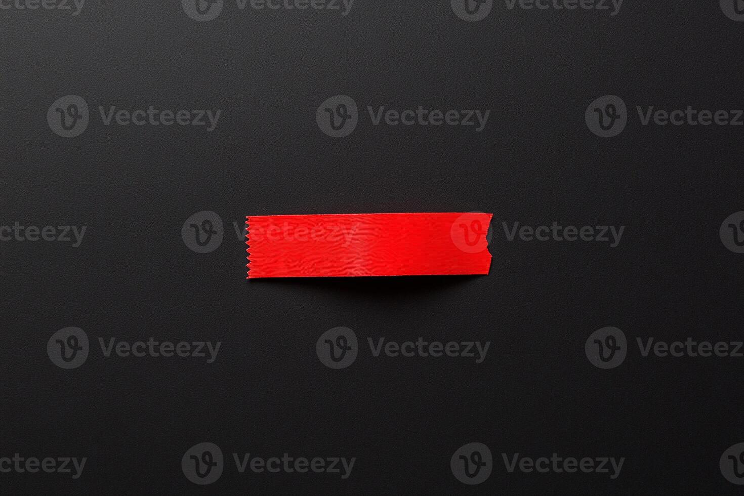 A red sticky note on a black surface photo