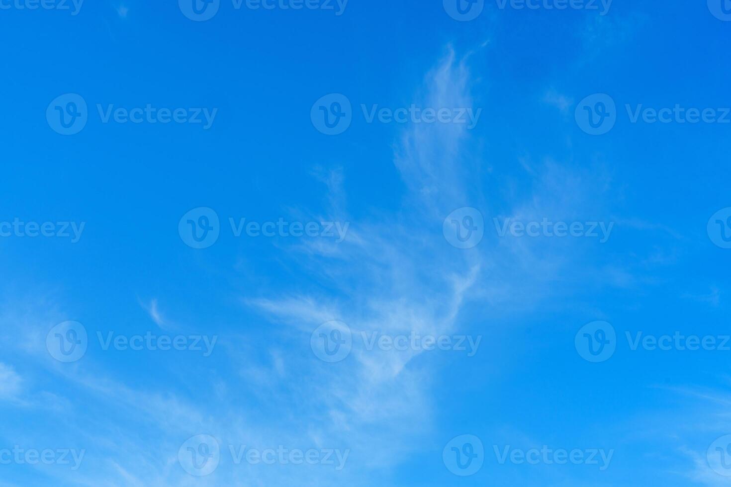 Expansive View of Wispy White Clouds Against a Vibrant Blue Sky in the Beautiful Netherlands photo