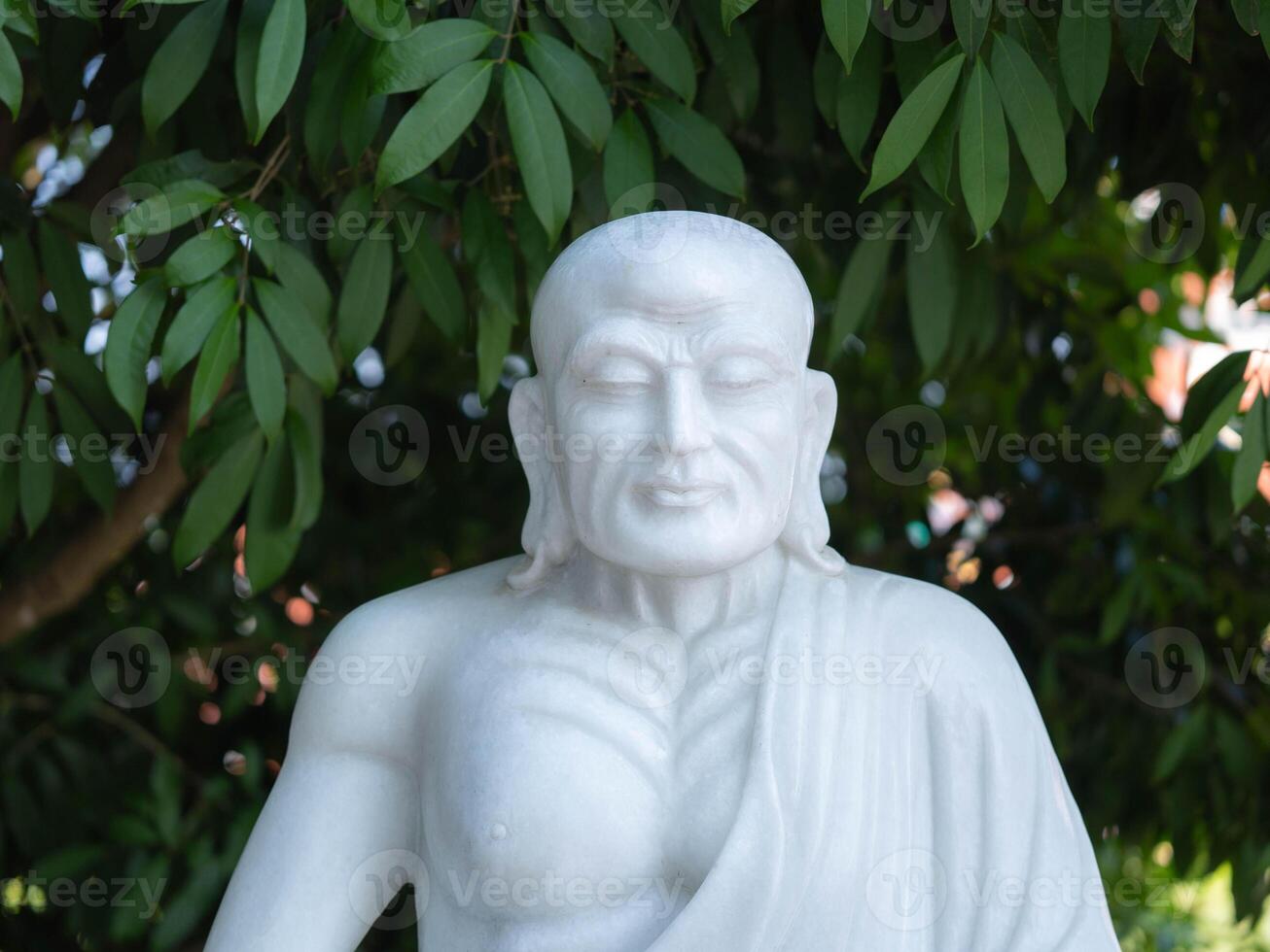 Marble carving of a Chinese monk. Chinese statue in temple. photo