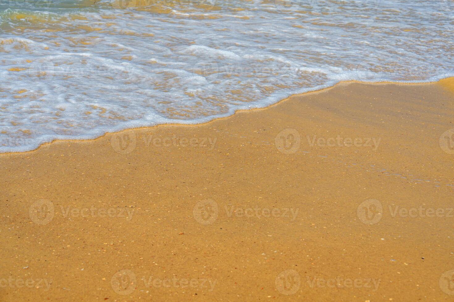 A person walking on a beach with a surfboard photo
