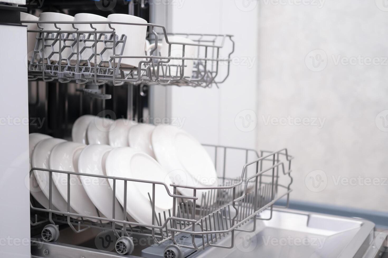 Built-in dishwasher door open, close-up photo