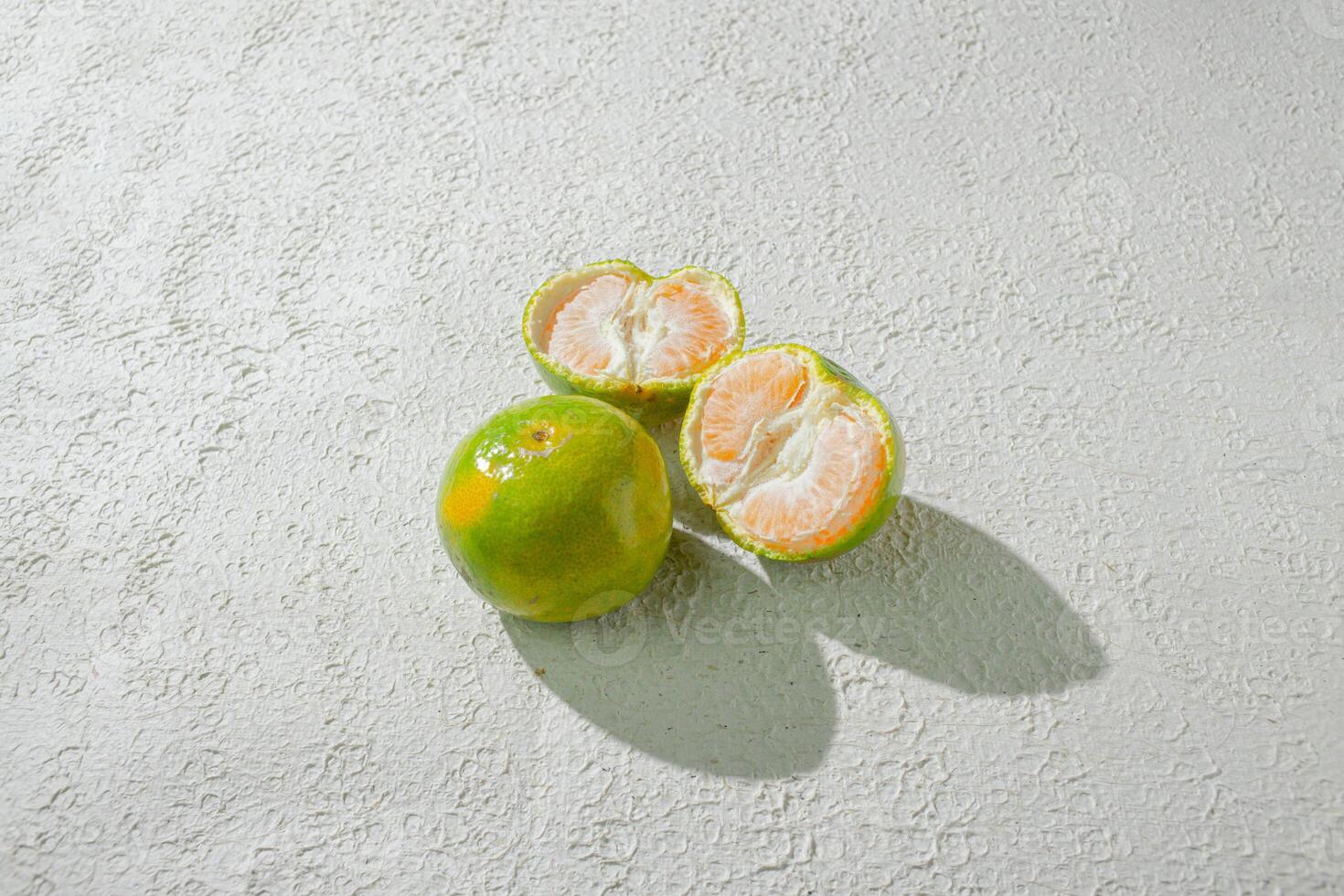 a opened orange on white wall background photo