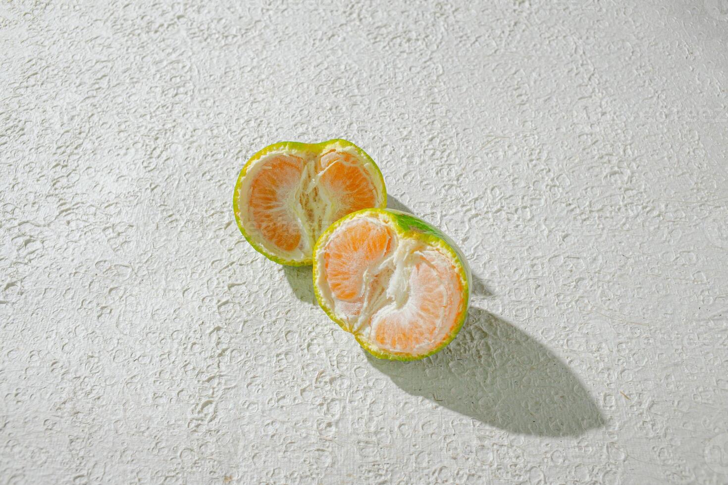 a half orange on a white surface photo