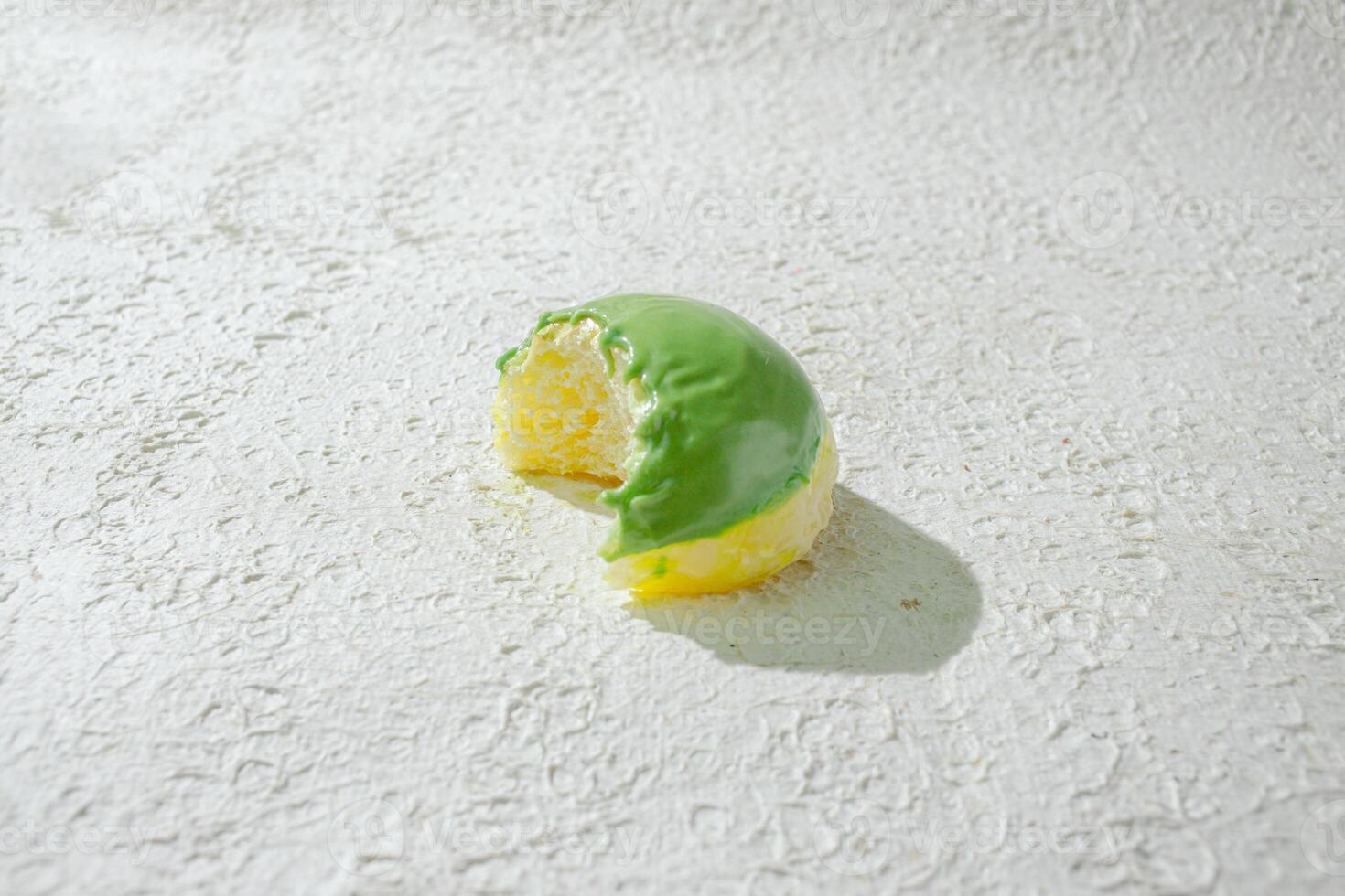 a half eaten mini donuts on a white surface photo