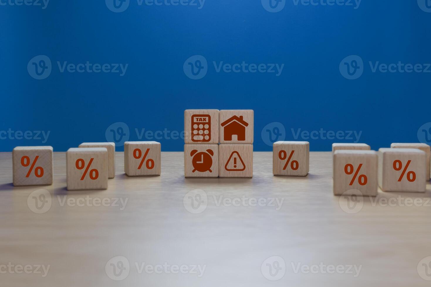 Home alert and calculator icons on wooden blocks. Annual tax calculation photo
