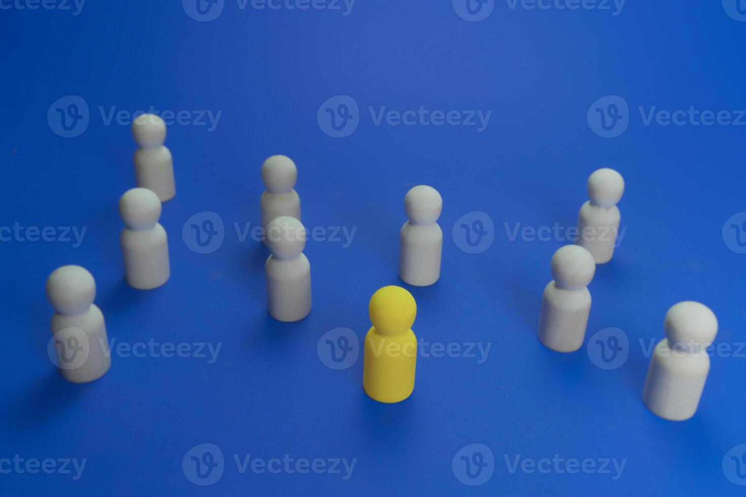 yellow wooden doll that is different from others photo