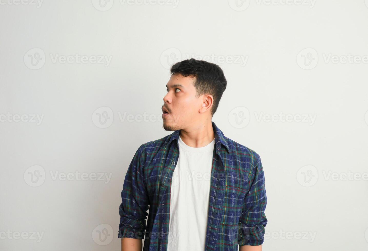 Omg. Portrait Of Surprised Asian Guy Opened Mouth In Amazement, Shocked Young Man Looking Stunned And Impressed, Emotionally Reacting To News photo