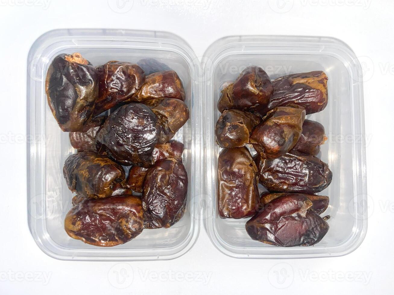 two plastic containers filled with dates photo