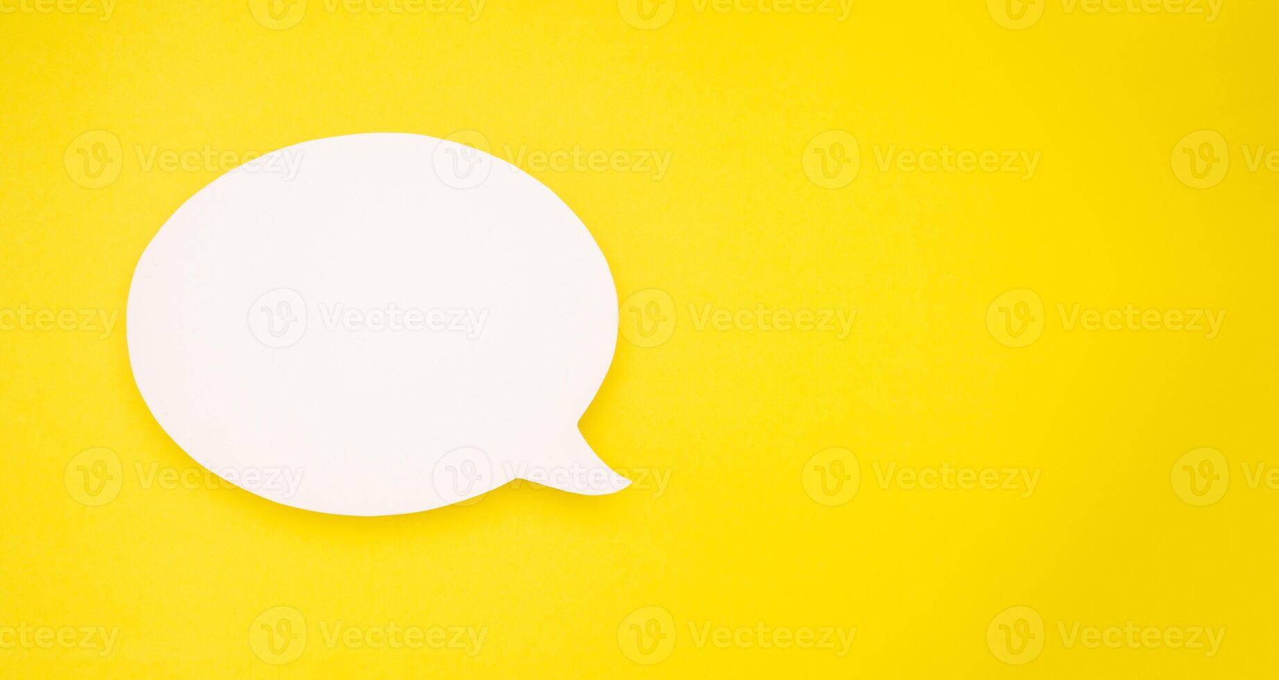 A blank white speech bubble over a light yellow background photo