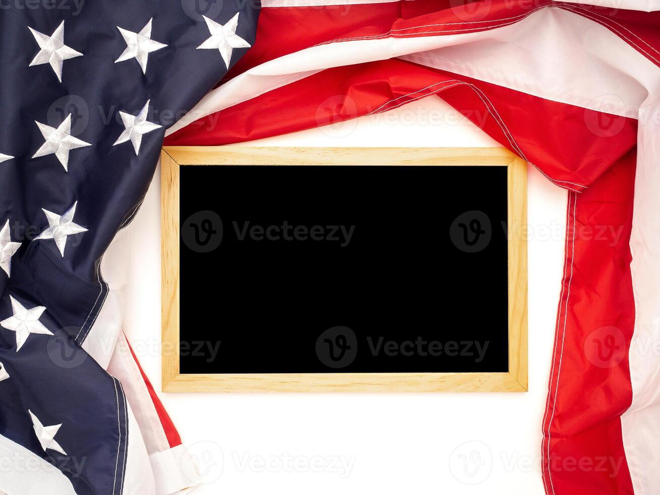 Top view of the American flag and empty mini blackboard on a white background photo
