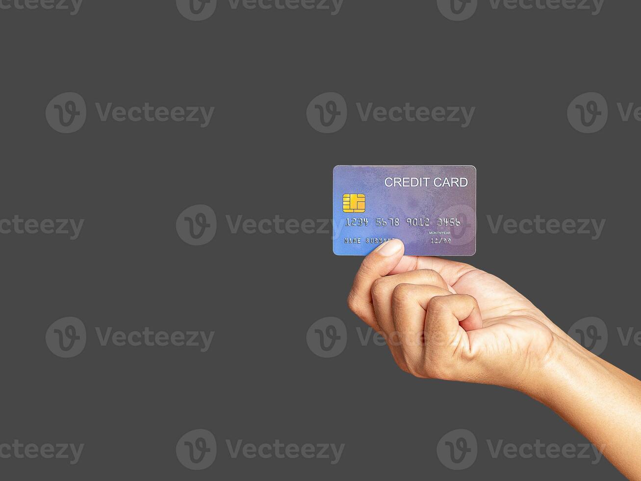 Hand of holding a mockup blue credit card while standing with gray background photo