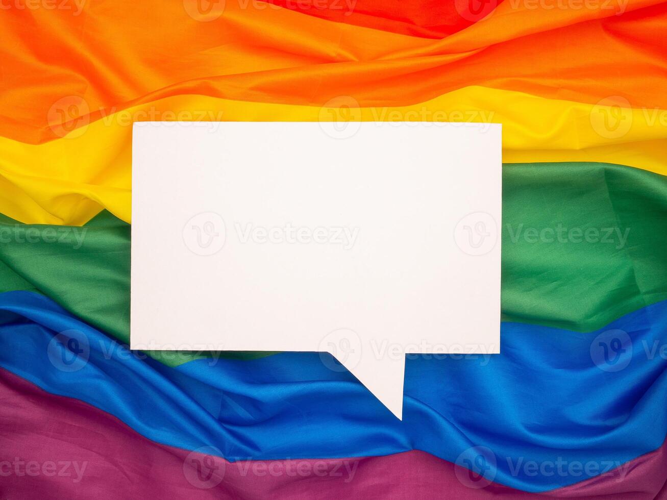 Top view of rainbow flag or LGBT flag with a blank white speech bubble photo