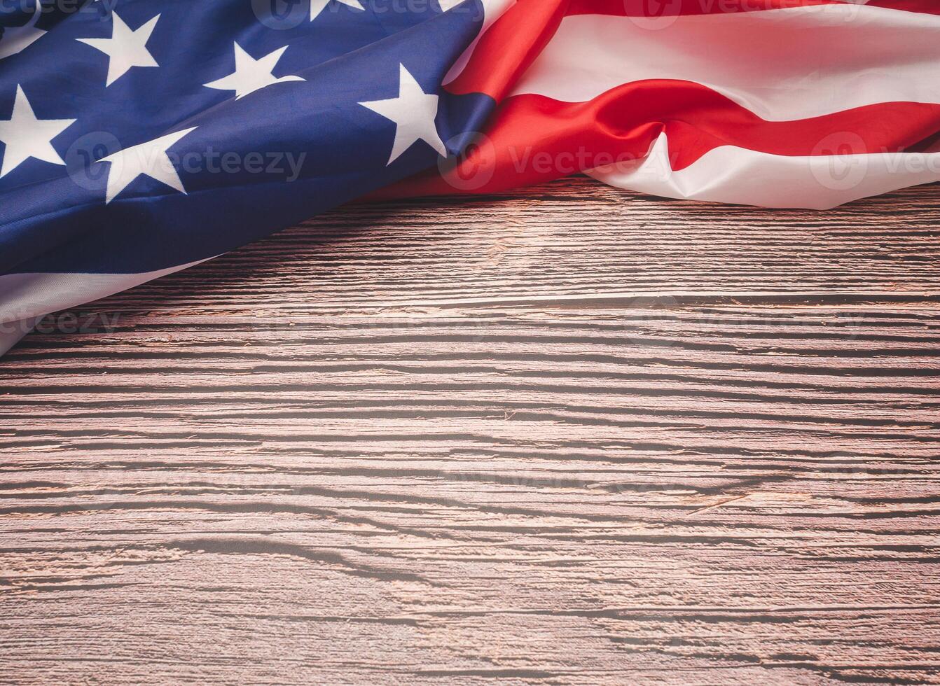 Top view of the American flag on a wooden table with copy space for text photo