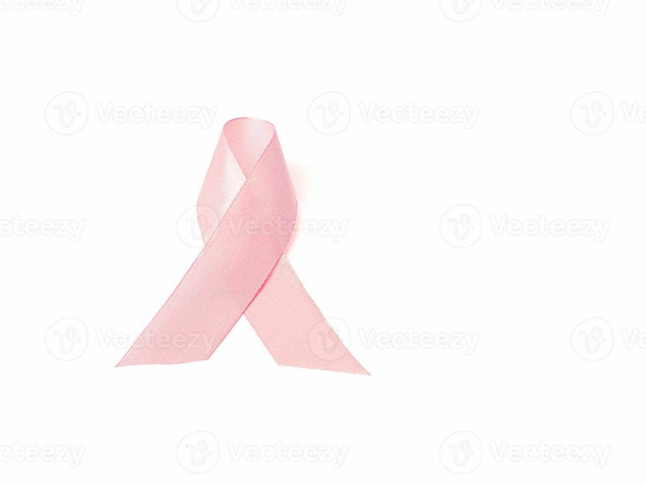 Top view of a pink ribbon for cancer patient support on a white background photo