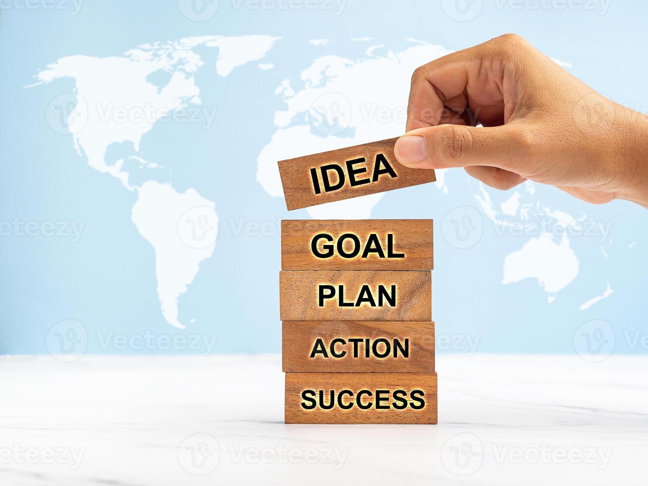 Business Planning Strategy. Wooden cubes with letters IDEA, GOAL, PLAN, ACTION, SUCCESS on a marble table photo