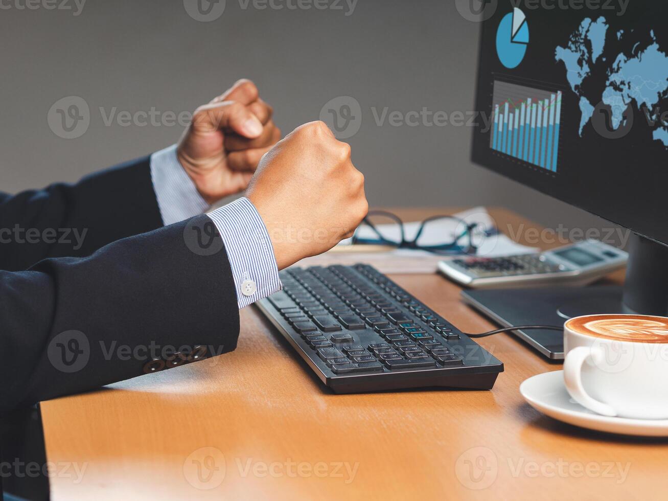 Businessman sitting working at a desktop computer in the office photo