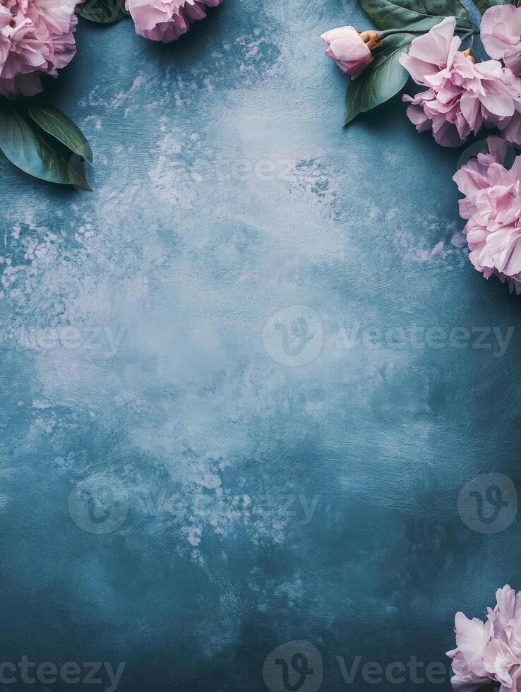 A serene blue background adorned with pink flowers, ideal for invitations or floral designs. photo