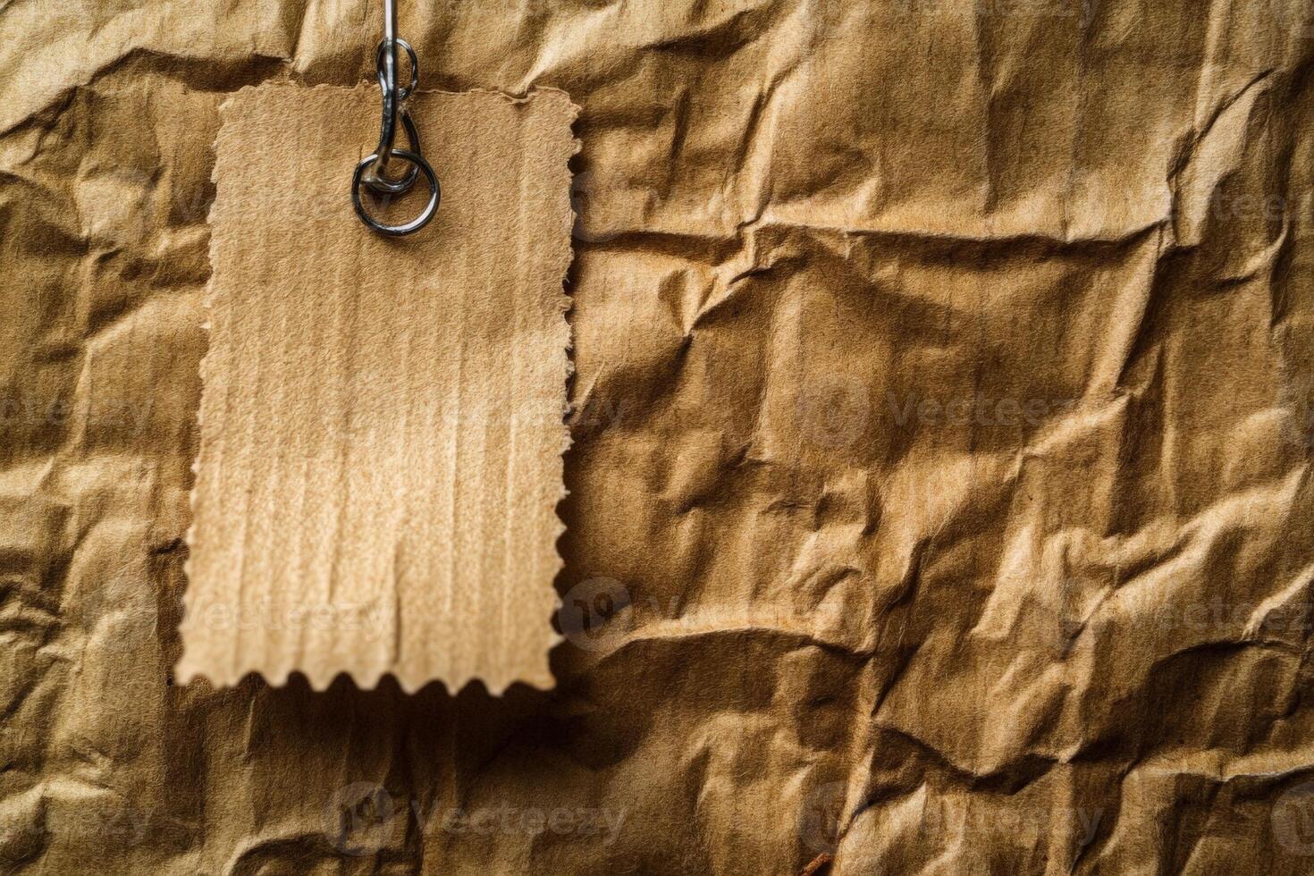 A textured brown background with a blank tag attached by a metal ring. photo