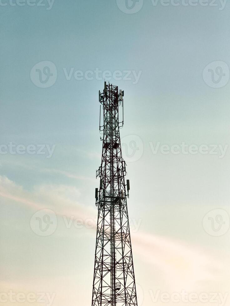Telecommunication Tower Against a Clear Sky at Sunset Capturing Modern Technology and Connectivity in a Serene Outdoor Setting photo