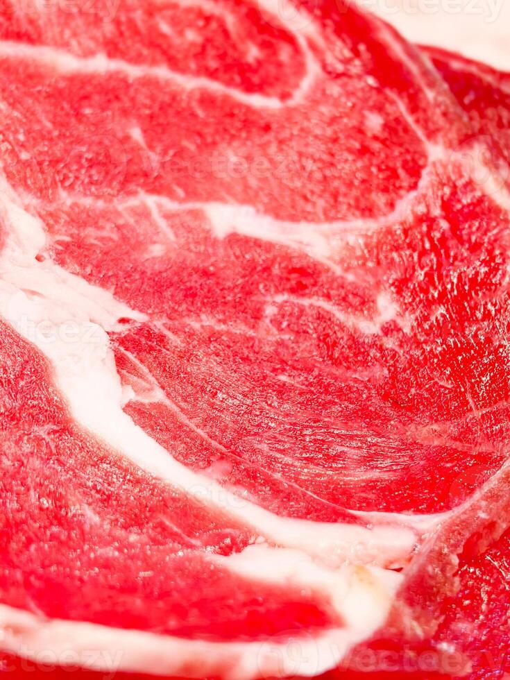 Close-Up of Fresh Marbled Beef Steak with Rich Red Color and Intricate Fat Patterns photo