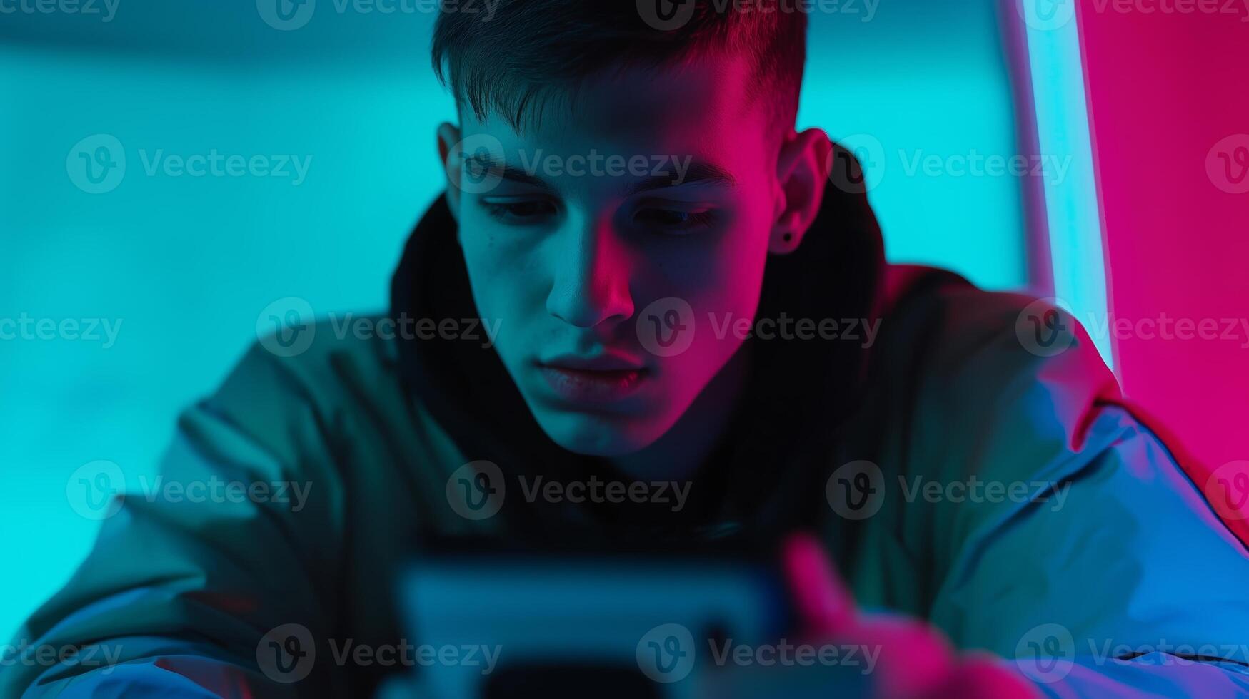Young caucasian man in neon light using smartphone reflecting modern technology trends. Social media addiction, internet addiction, smartphone addiction. Social disease. photo