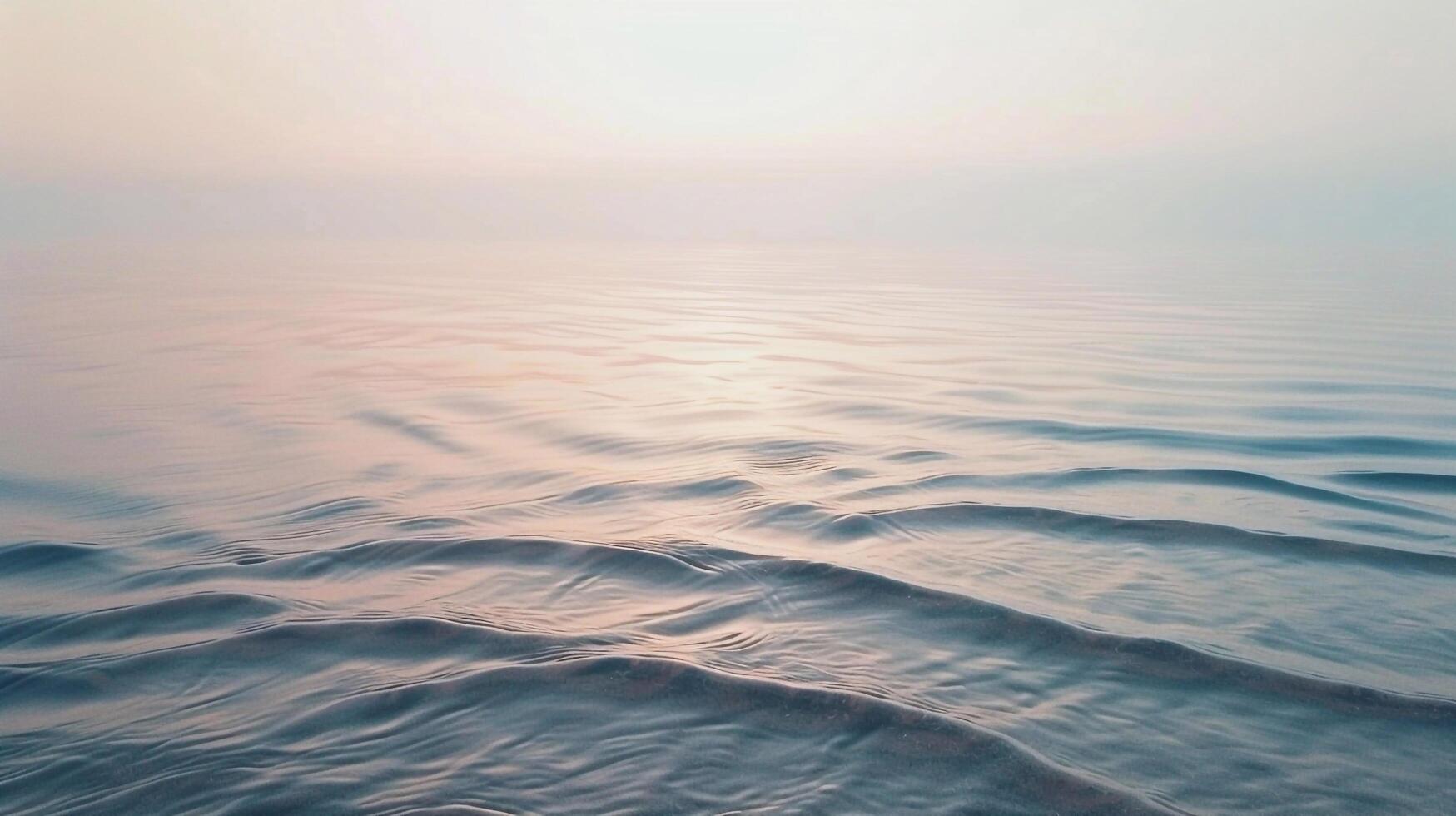 A view of the ocean at sunset with waves photo
