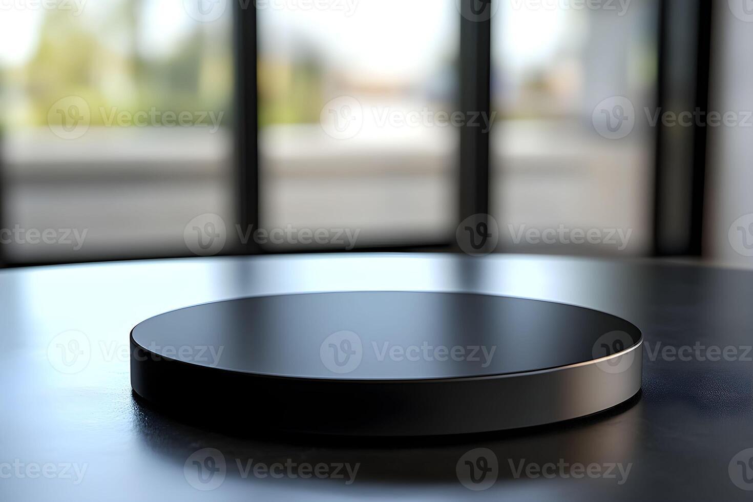A black circular object on a table in front of a large window photo
