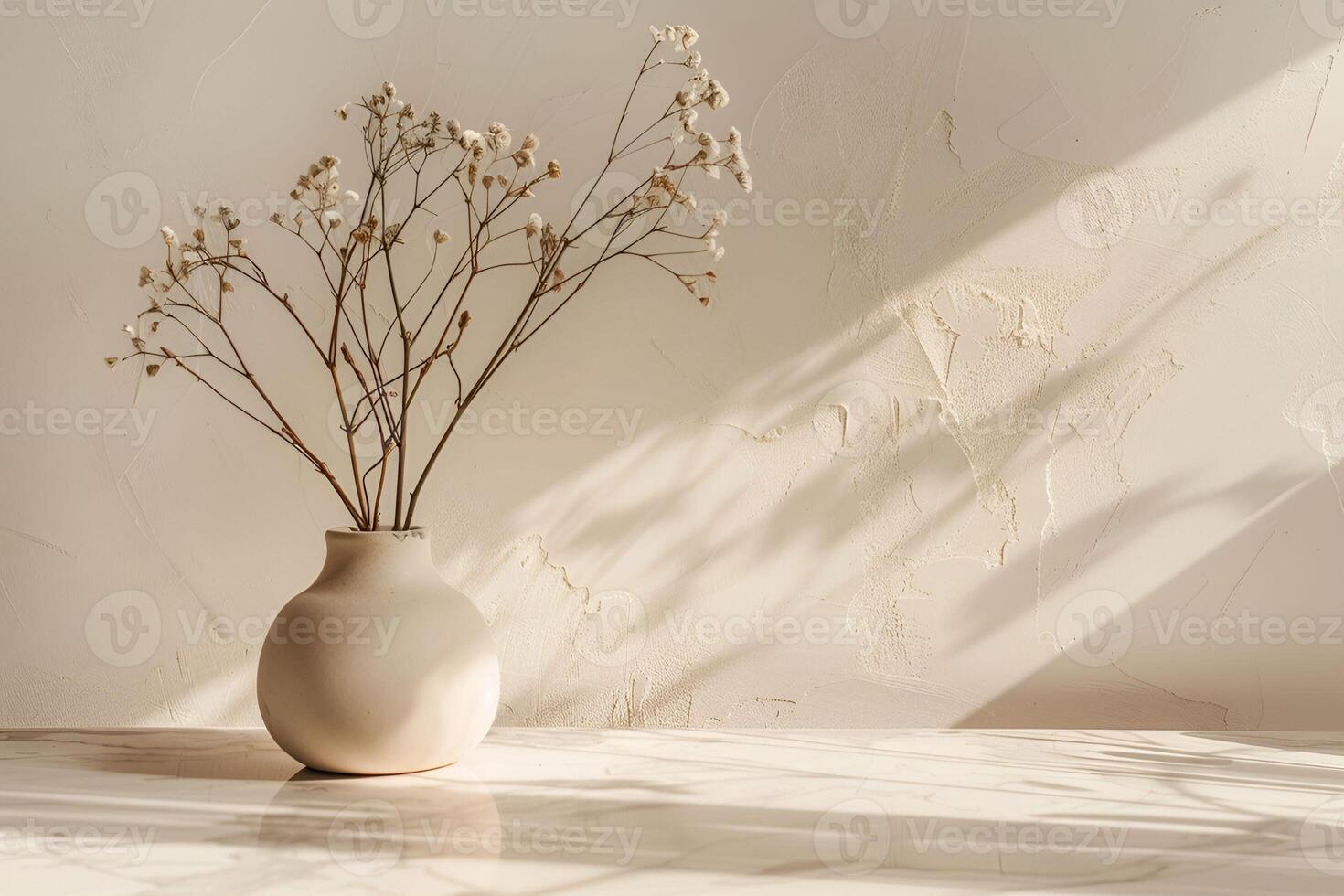 A vase with dried flowers sitting on a table photo