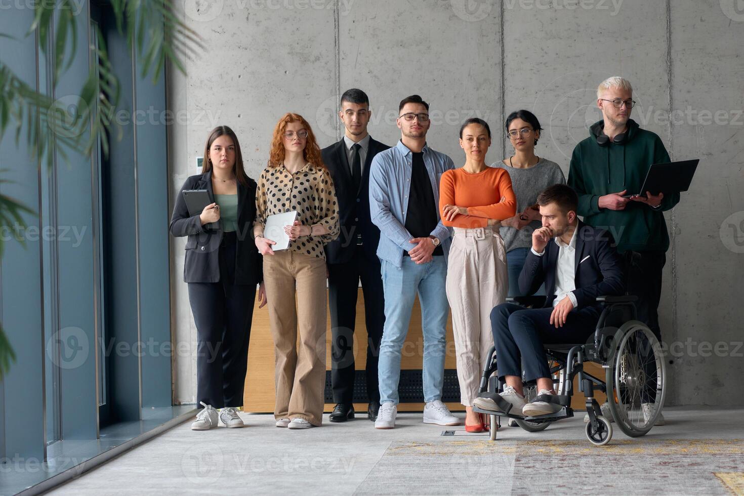 Multiethnic Business Team Collaborating in a Modern Office with Director in a Wheelchair photo
