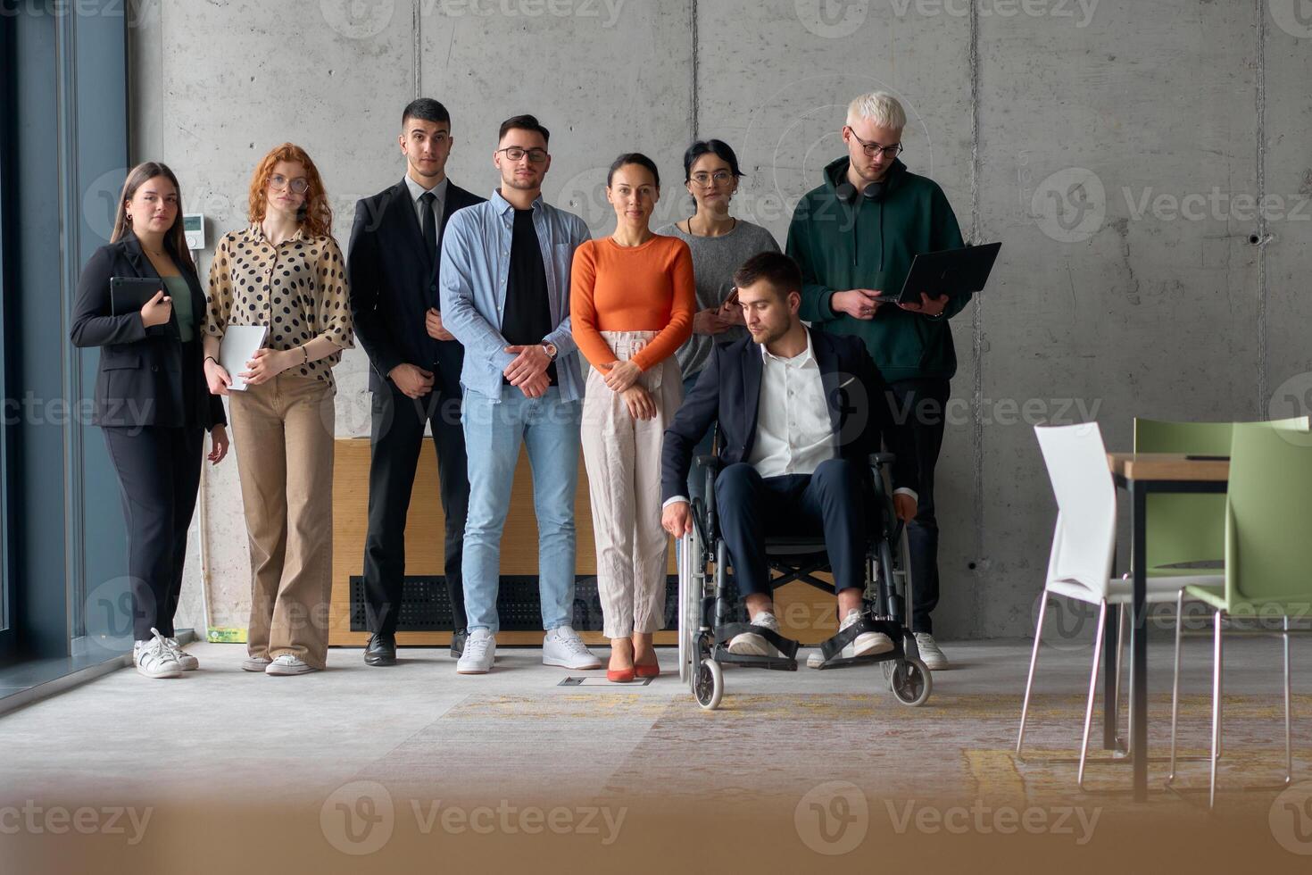 Multiethnic Business Team Collaborating in a Modern Office with Director in a Wheelchair photo