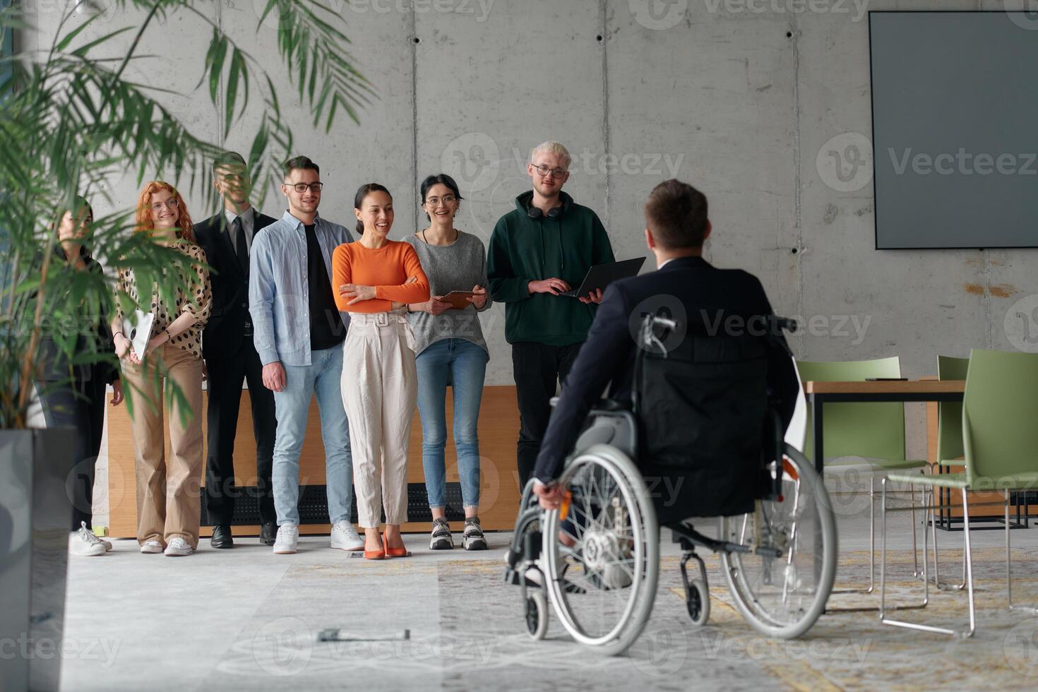 Multiethnic Business Team Collaborating in a Modern Office with Director in a Wheelchair photo