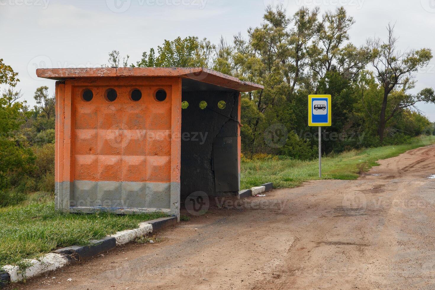 empty old bus stop on the road photo