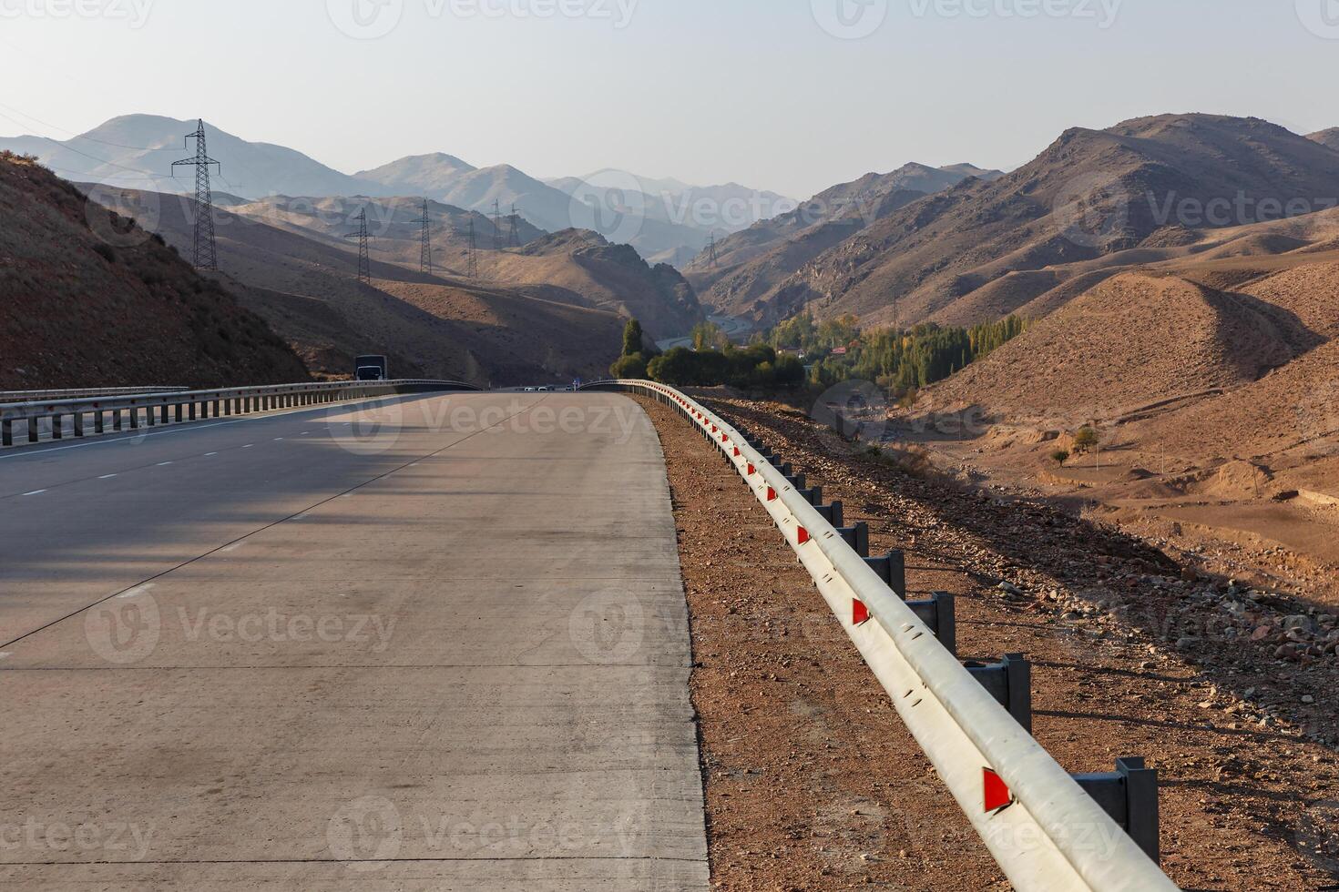 A 373 Tashkent Osh highway in Uzbekistan. iron fence on a mountain road photo