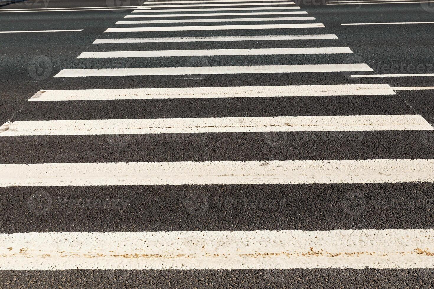 Pedestrian road crossing, white marking on an asphalt road. photo