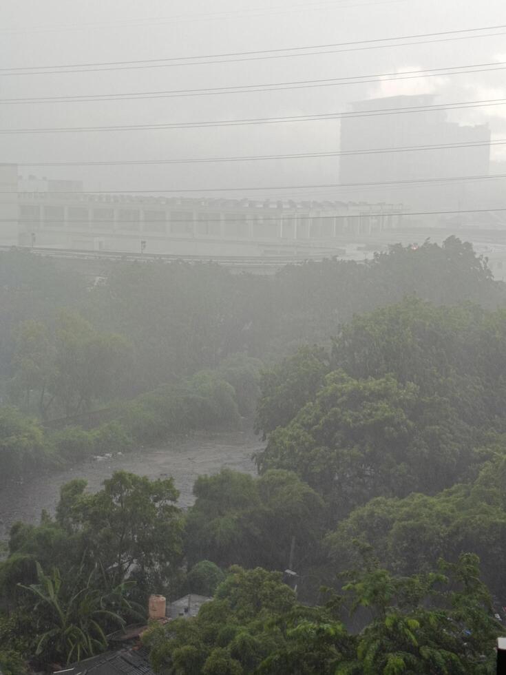Foggy city view during heavy rain photo