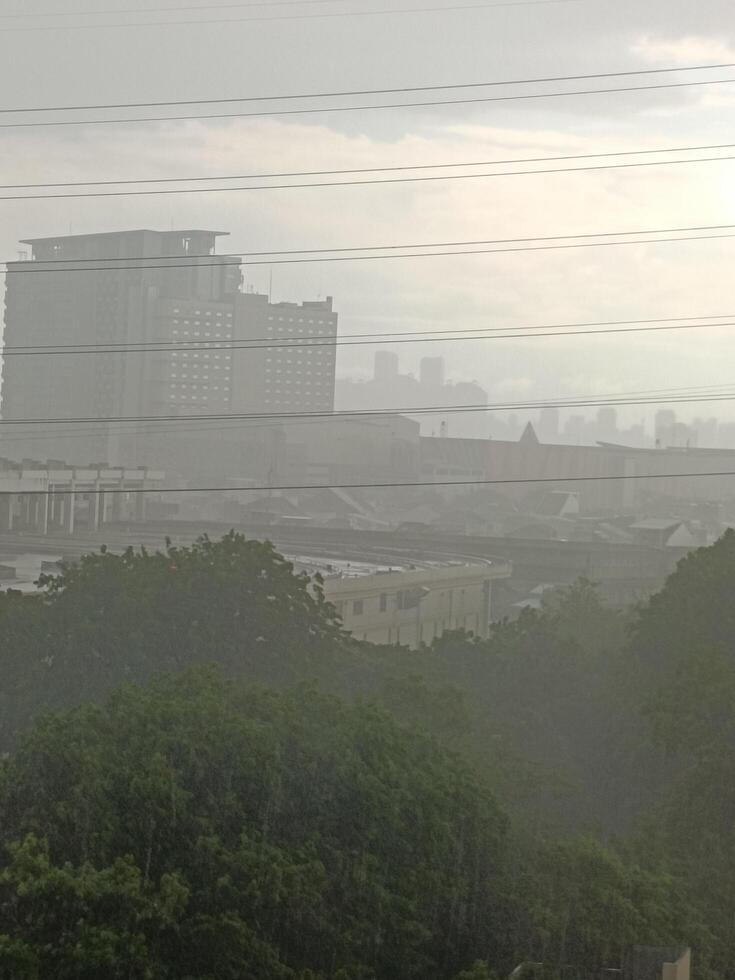 Foggy afternoon view during heavy rain and wind photo