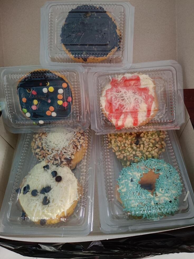Delicious fried donuts with various topping photo