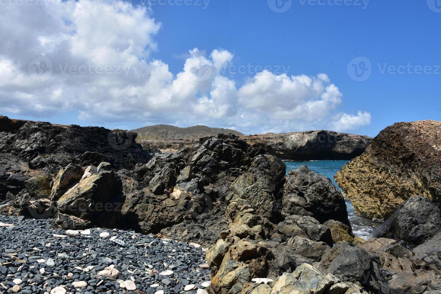 Rugged Rocks Surrounding a Cove in Aruba photo