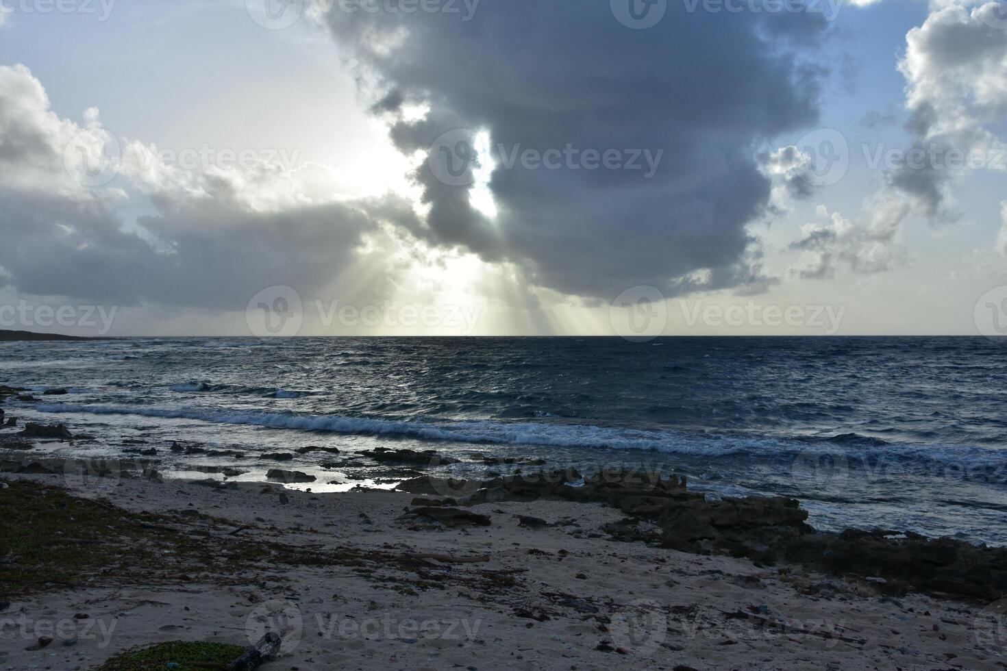 Amazing Rays of Sun Shining Through Clouds on Ocean photo