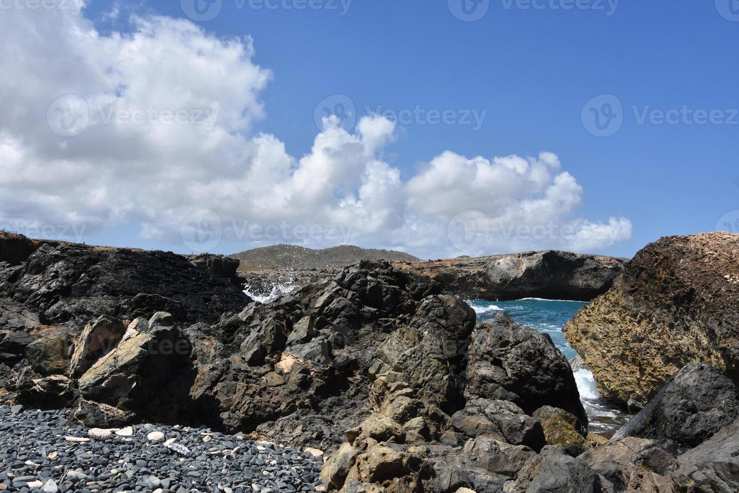 Waves Splashing Over Scattered Rocks in Aruba photo
